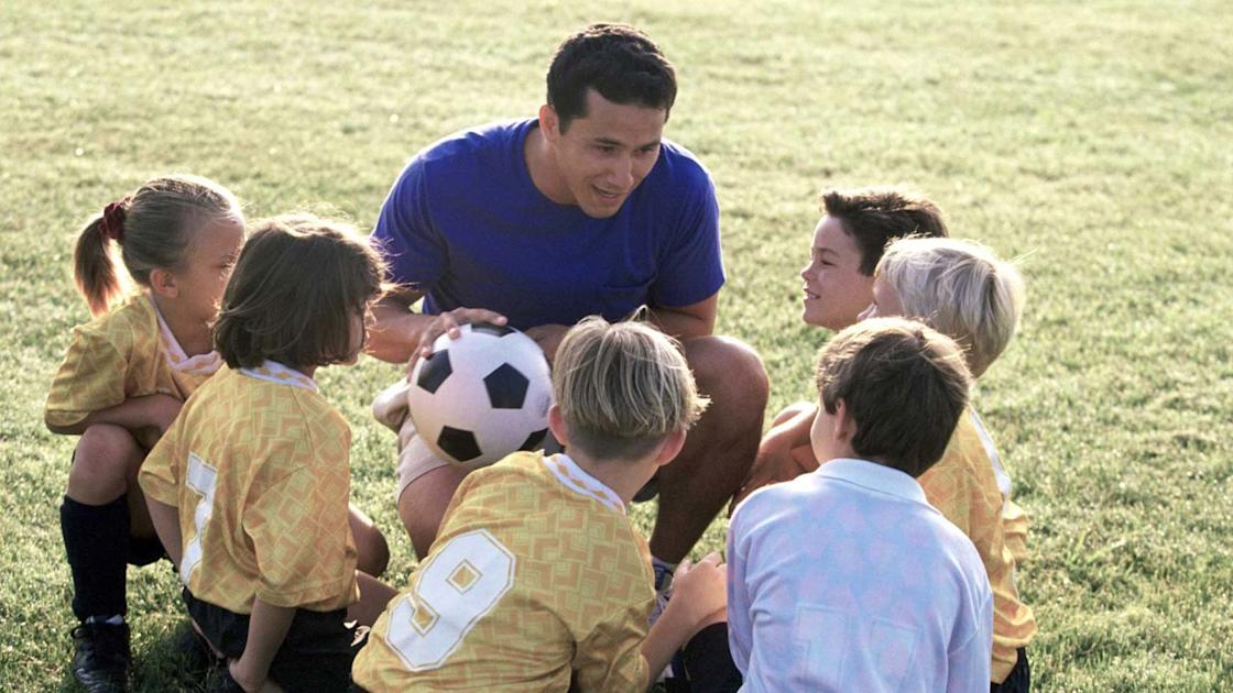 Football coach working with players